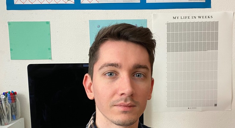 Freelancer and writer Alex Lloyd with his 4K Weeks calendar above his desk on the righthand side.