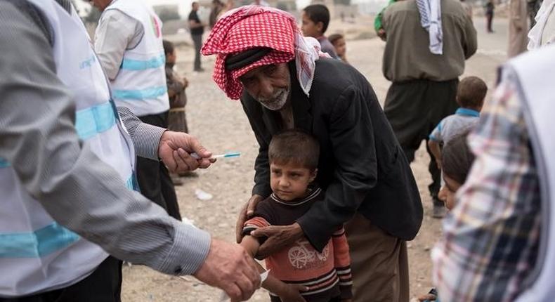 A displaced boy, who fled the violence in Mosul, receives a measles vaccination from a UNICEF-supported health worker in Ibrahim Khalil village in Hamdaniyah, Iraq October 24, 2016. Picture taken October 24, 2016.