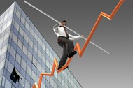 Businessman on a finance graphic aiming for the top..