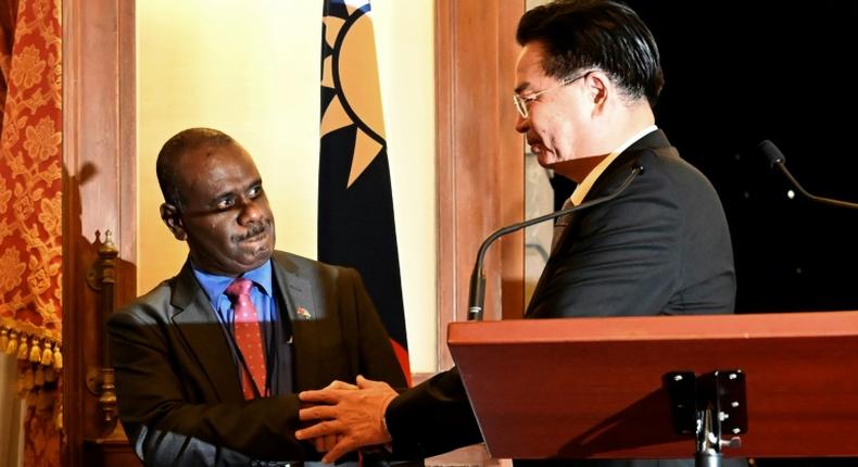 Taiwan Foreign Minister Joseph Wu shakes hands with Solomon Islands' Foreign Minister Jeremiah Manele during a press conference in Taipei. The Solomon Islands is mulling scrapping diplomatic links with Taipei in favour of Beijing