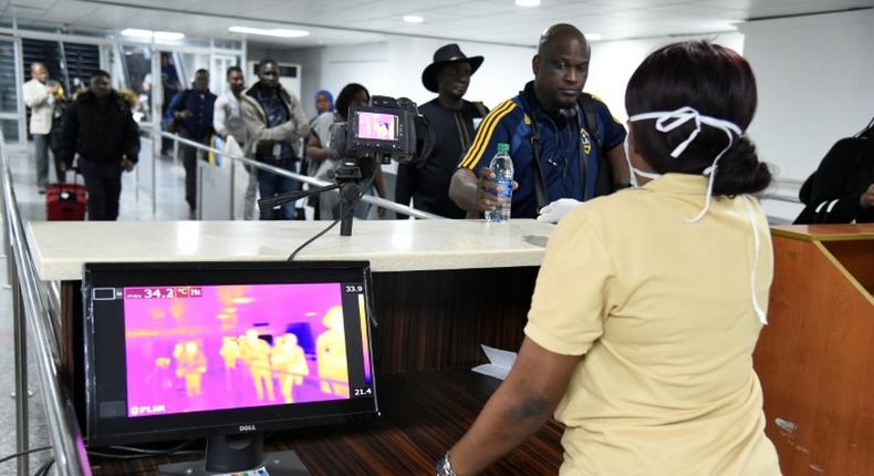 A thermal scanner screens passengers at Lagos international airport