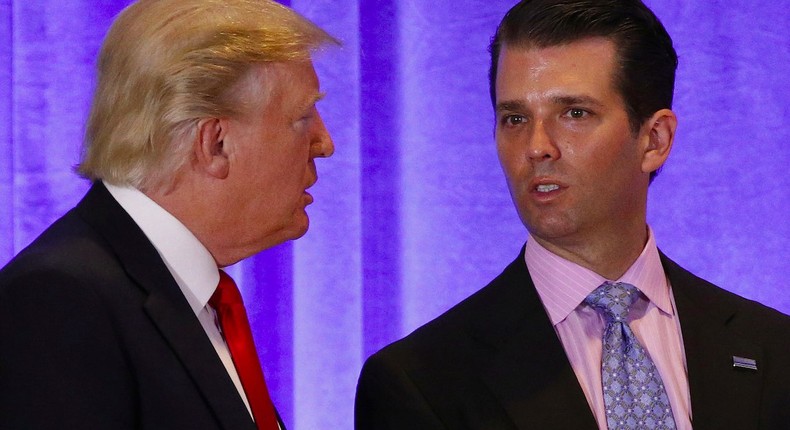 Then-President-elect Donald Trump speaks with his son Donald Trump Jr. during a news conference in the lobby of Trump Tower in Manhattan on January 11, 2017.