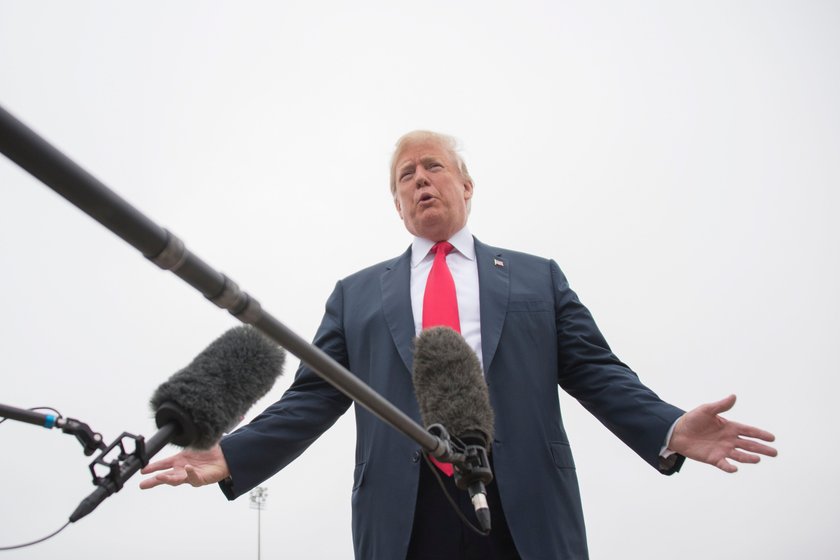 U.S. President Donald Trump walks from Air Force One as he arrives in Dallas, Texas