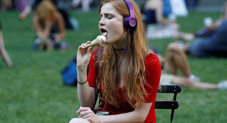 Woman Eating Ice Cream Cone Outside