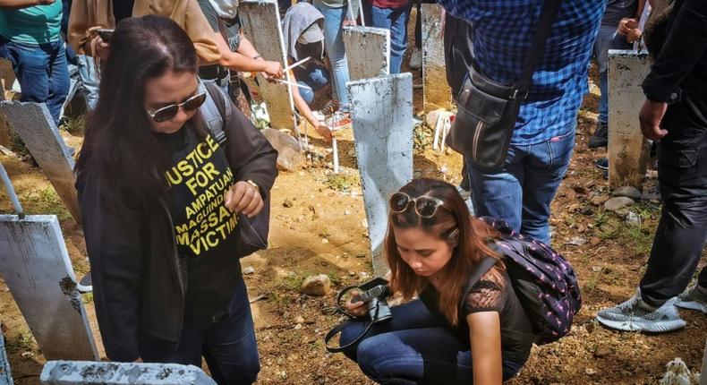 On the 10th anniversary, relatives visit the site of the massacre where markers represent the 58 victims of the November 23, 2009 killings