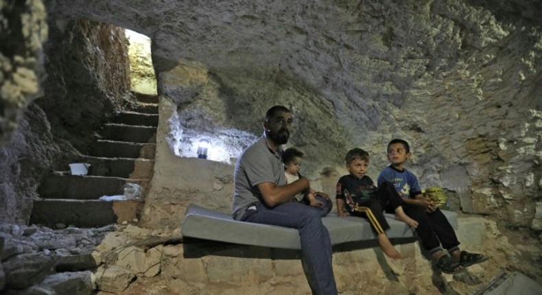 A Syrian family hides in a custom-built cave in Idlib province as negotiations continue to avoid a massive government offensive on the area