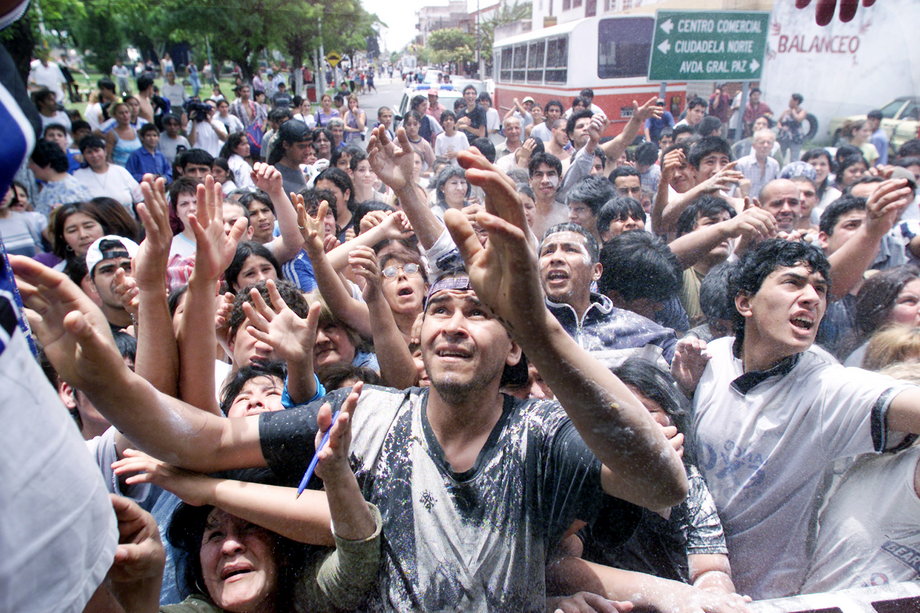 Unemployed Argentines demand food at the gate of a supermarket on the outskirts of Buenos Aires on December 19, 2001. Police in riot gear fired tear gas and rubber bullets to disperse looters who ransacked shops and supermarkets in the capital and northern part of the country, in some of the worst rioting in more than a decade.