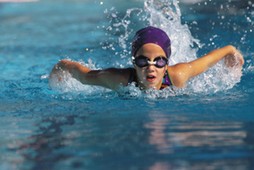 A young girl swimming in a pool