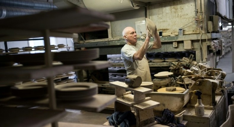 A worker produces crockery in the Emma Bridgewater factory, which employs around 185 people and manufactures 1.3 million pieces of pottery each year in the centre of Stoke-on-Trent