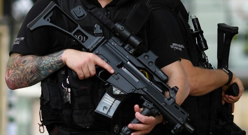 Armed police stand secure a street in central Manchester, on May 24, 2017