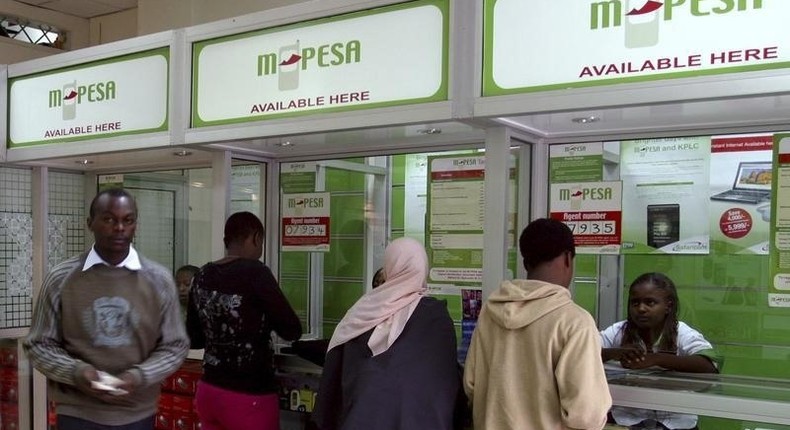 A man leaves an M-PESA booth after a money transaction in Nairobi, in a file photo. Picture taken May 12, 2009. REUTERS/Noor Khamis