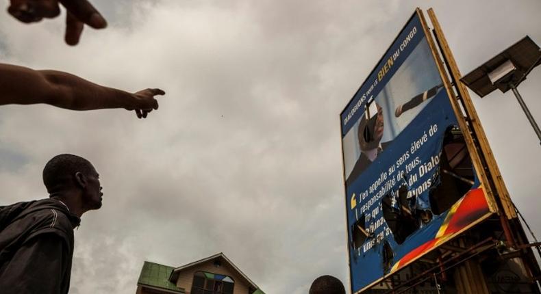 A broken billboard showing the face of Congolese President Joseph Desiree Kabila during an opposition rally in Kinshasa in September 2016