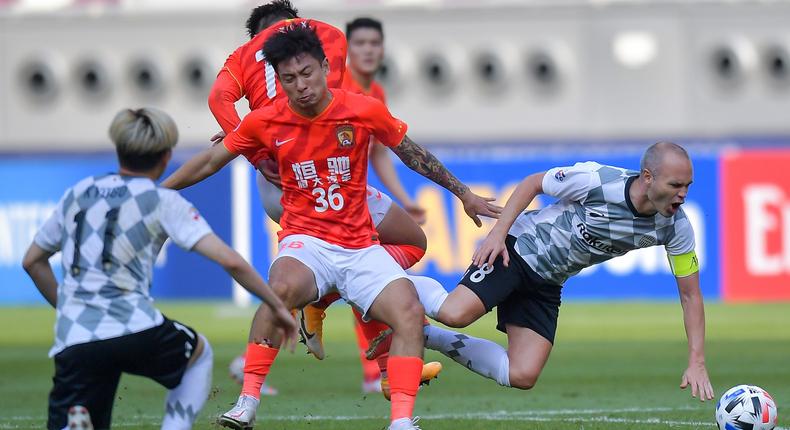 Evergrande FC players (in red) play in the Asian Football Champions League.
