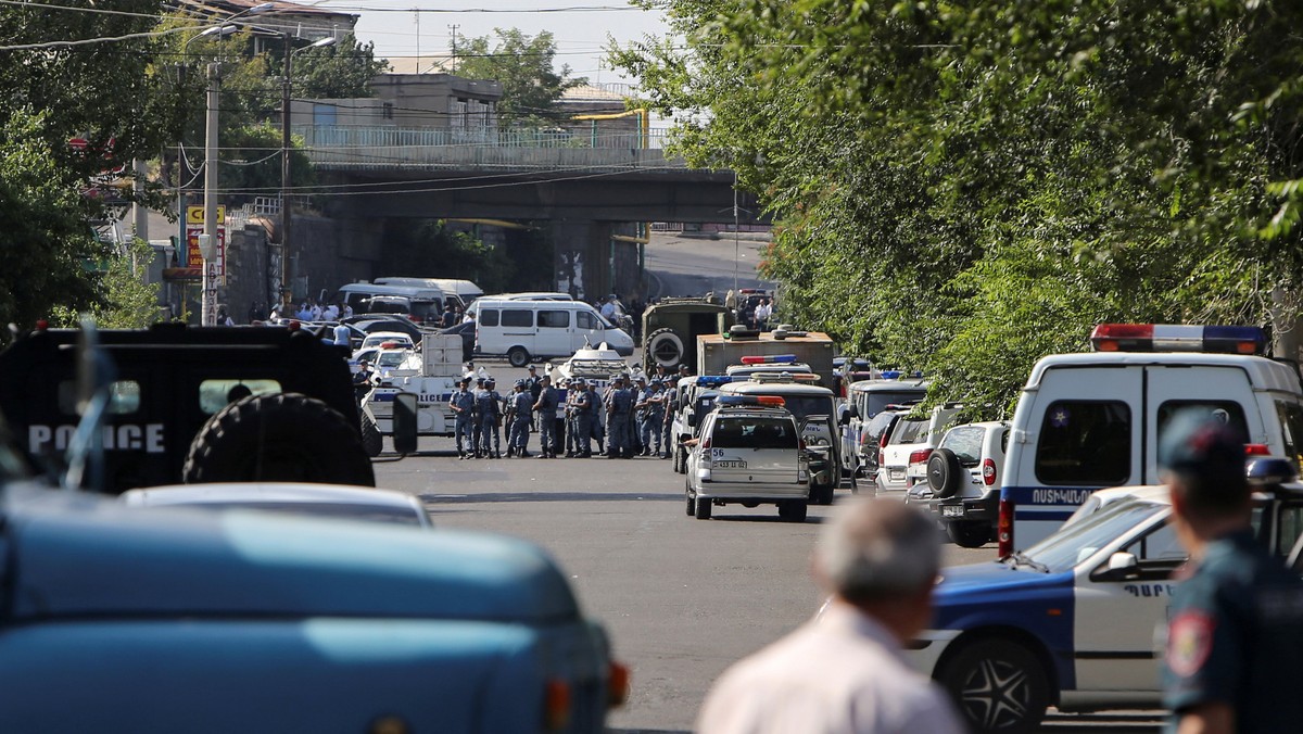 Policemen block a street after group of armed men seized a police station along with an unknown number of hostages, according the country's security service, in Yerevan, Armenia