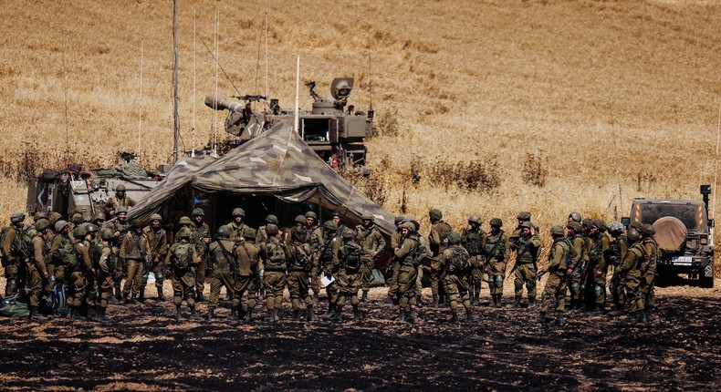 Israeli soldiers of an artillery unit gather near the border between Israel and the Gaza Strip, on its Israeli side, May 14, 2021.
