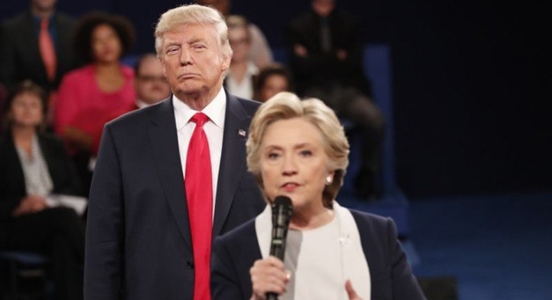 Donald Trump listens as Hillary Clinton answers a question from the audience.