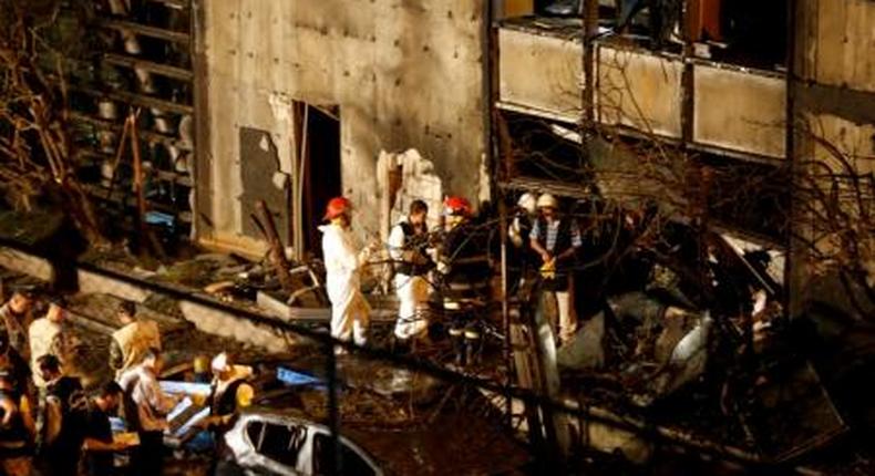 Forensic inspectors examine the site of an explosion at the headquarters of the Lebanese Blom Bank in Beirut, Lebanon June 12, 2016.