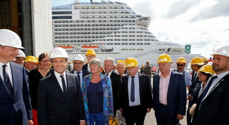 French Economy Minister Bruno Le Maire (L), French President Emmanuel Macron (2ndL), attend the delivery ceremony of the MSC Meraviglia cruise ship on May 31, 2017 at the STX shipyard of Saint-Nazaire, western France