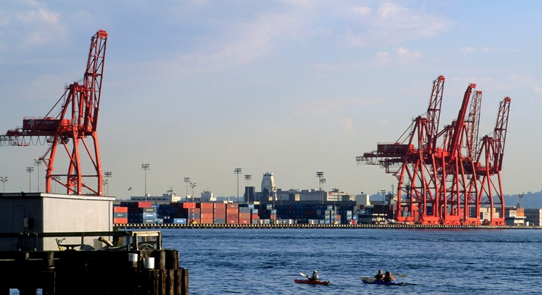 Kayakers pass Seattle's container port.