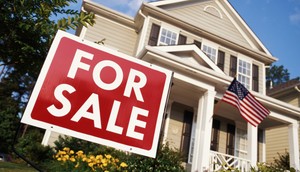 House with American flag and 'for sale' sign, low angle view - stock photoPhillip Spears/ Getty Images