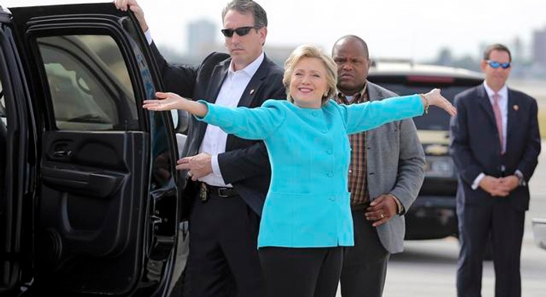 U.S. Democratic presidential candidate Clinton reacts before boarding her campaign plane at Miami international airport in Miami