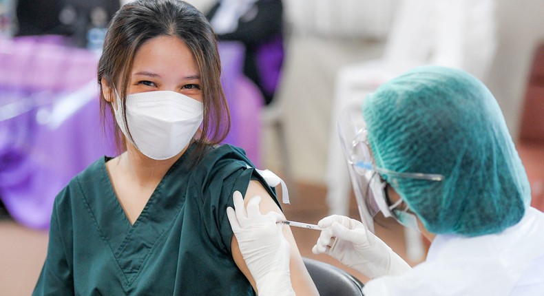 A healthcare worker receives a booster dose of Pfizer's vaccine in Bangkok on August 9, 2021.
