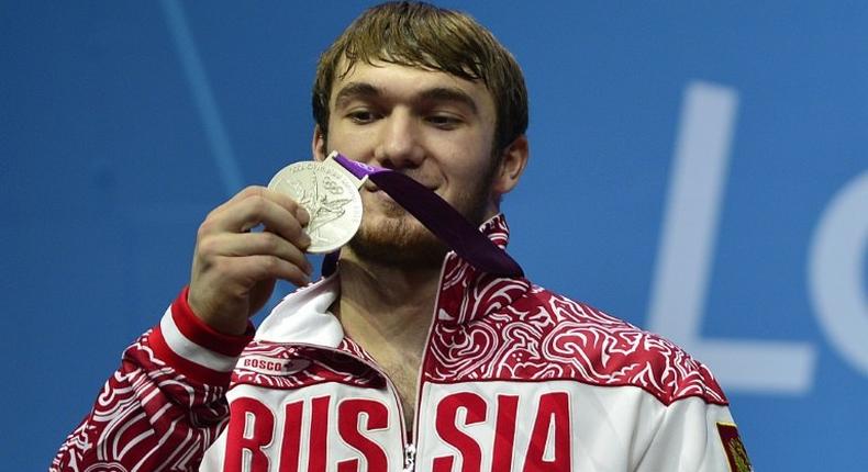 Russia's Apti Aukhadov, pictured on the podium of the men's 85kg weightlifting event at the 2012 Olympic Games, was stripped of his silver medal by the IOC after a sample re-test came back positive for drugs