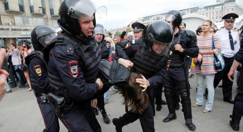 Russian police officers detain participants of an unauthorized opposition rally in Tverskaya street in central Moscow on June 12, 2017