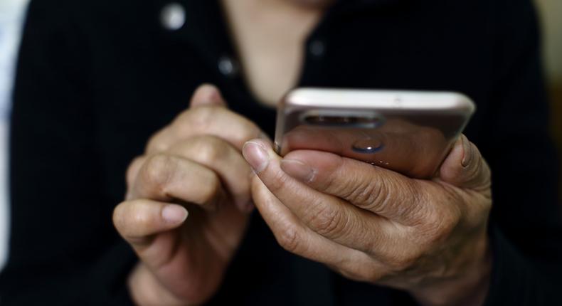 A stock photo shows a woman using a smartphone.Getty Images
