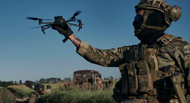 A Ukrainian soldier of the 28th brigade launches a drone at the front-line close to Bakhmut in August 2023.AP Photo/Libkos