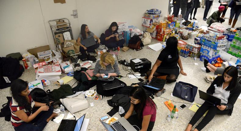 Lawyers and legal assistants in the baggage claim area at Dulles Airport on January 29 work to aid passengers who arrived and encountered problems because of Donald Trump's travel ban.