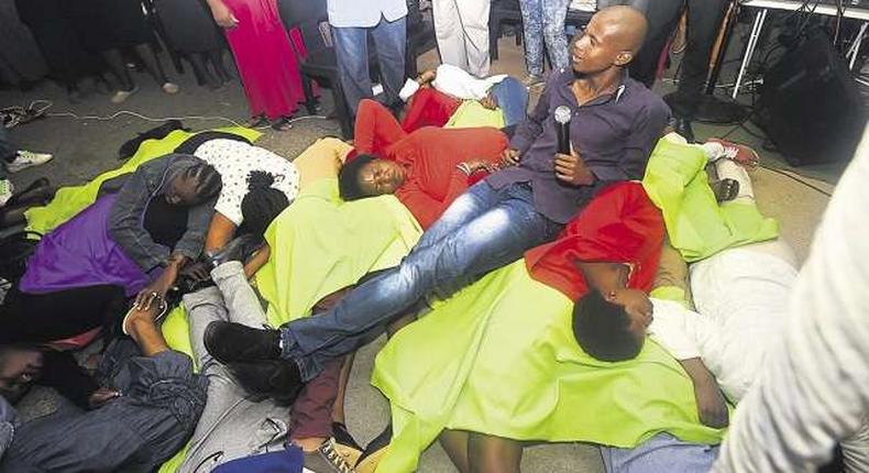 Pastor Penuel Mnguni sits on church members, tired from masturbating 