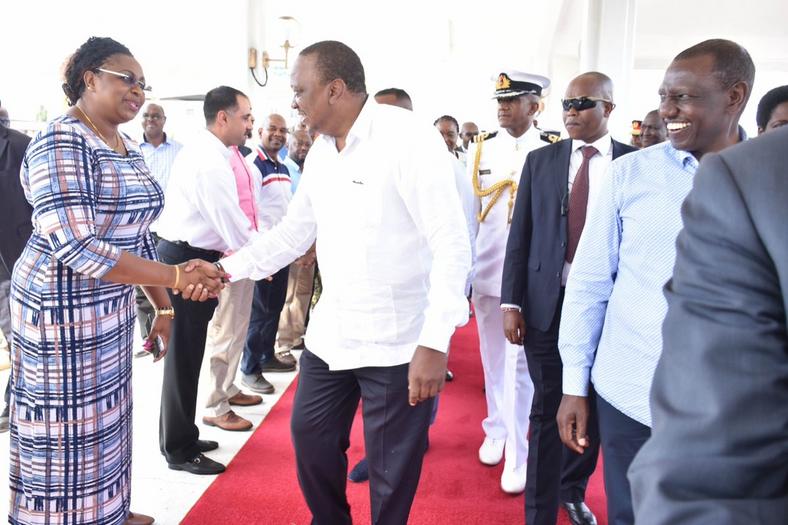 President Kenyatta shakes hands with MP Aisha Jumwa after receiving President Yoweri Museveni at Moi International Airport, Mombasa 