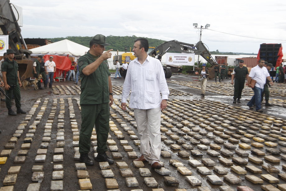 Venezuela's then interior minister, Tareck El Aissami, right, walks over confiscated cocaine packs presented to the media in Puerto Ordaz in the southern state of Bolivar, June 26, 2011.