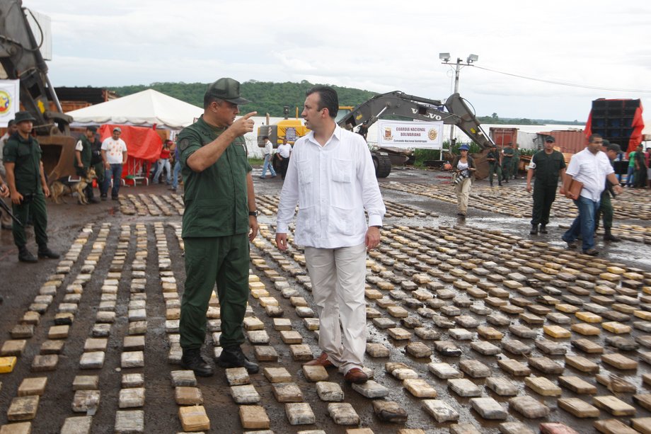 Venezuela's then interior minister, Tareck El Aissami, right, walks over confiscated cocaine packs presented to the media in Puerto Ordaz in the southern state of Bolivar, June 26, 2011.