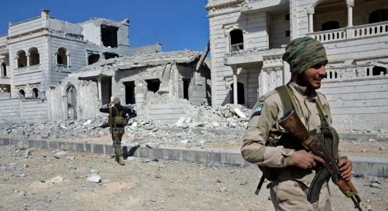 Rebel fighters, seen here, are working with Turkish troops to flush out IS jihadists from Al-Bab