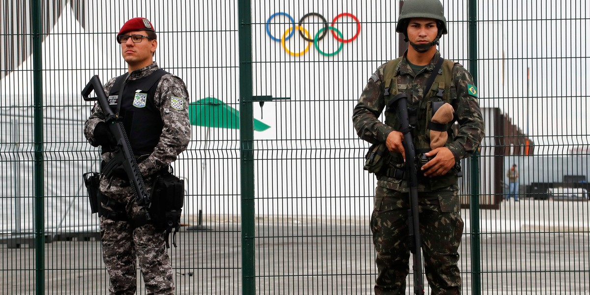 The Brazilian Public Safety National Force, left, and military-police soldiers guard an entrance outside of the 2016 Rio Olympics Park in Rio de Janeiro, Brazil, on July 21.