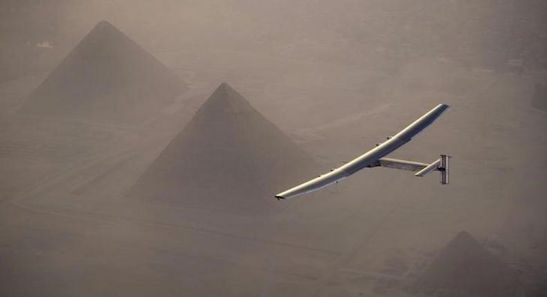 Solar Impulse 2, the solar powered plane, piloted by Swiss pioneer Andre Borschberg is seen during the flyover of the pyramids of Giza on July 13, 2016 prior to the landing in Cairo, Egypt in this photo released on July 13, 2016. Jean Revillard/SI2/Handout via Reuters