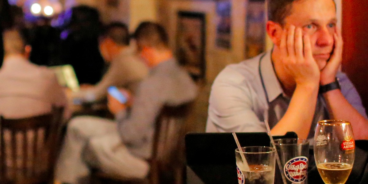 People gathered in The Churchill Tavern, a British-themed bar in Manhattan, react as the BBC predicts Britain would leave the EU.