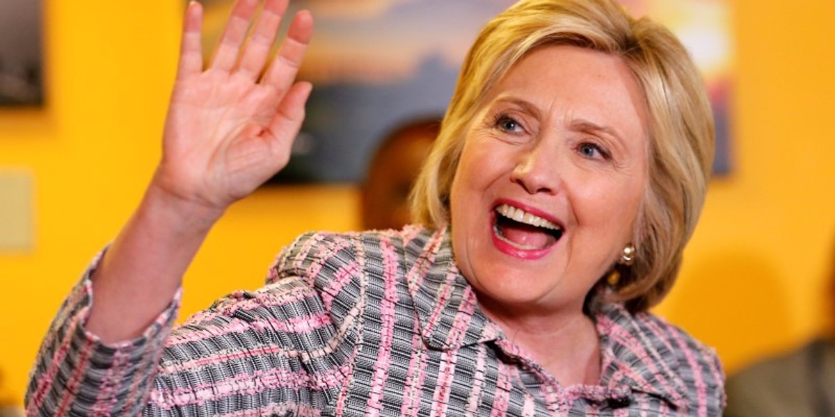 U.S. Democratic presidential candidate Hillary Clinton waves as she sits down to talk during a campaign stop at a small restaurant in Vallejo, California