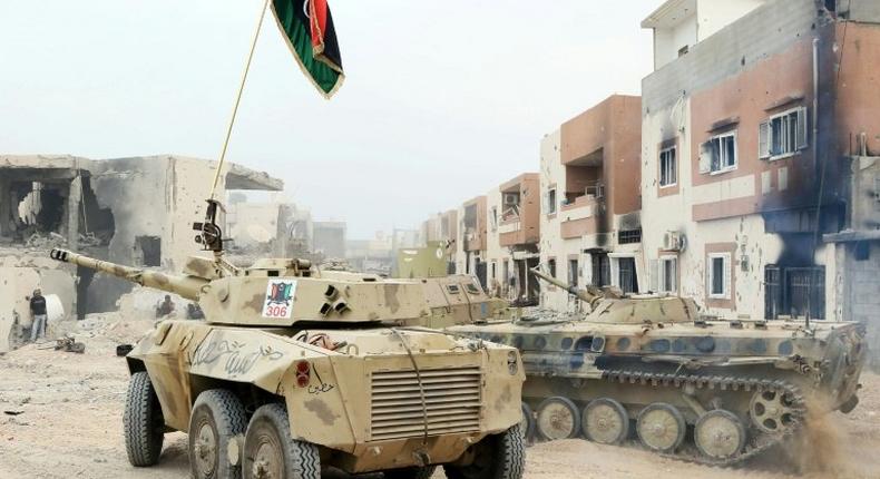 Infantry fighting vehicles belonging to forces loyal to Libya's Government of National Accord take position in Sirte's Al-Giza Al-Bahriya district on November 21, 2016