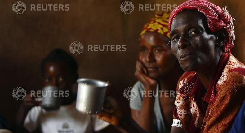 HIV-positive members of a self-help group meet with a caregiver in the village of Michelo, south of the Chikuni Mission in the south of Zambia February 23, 2015. REUTERS/Darrin Zammit Lupi