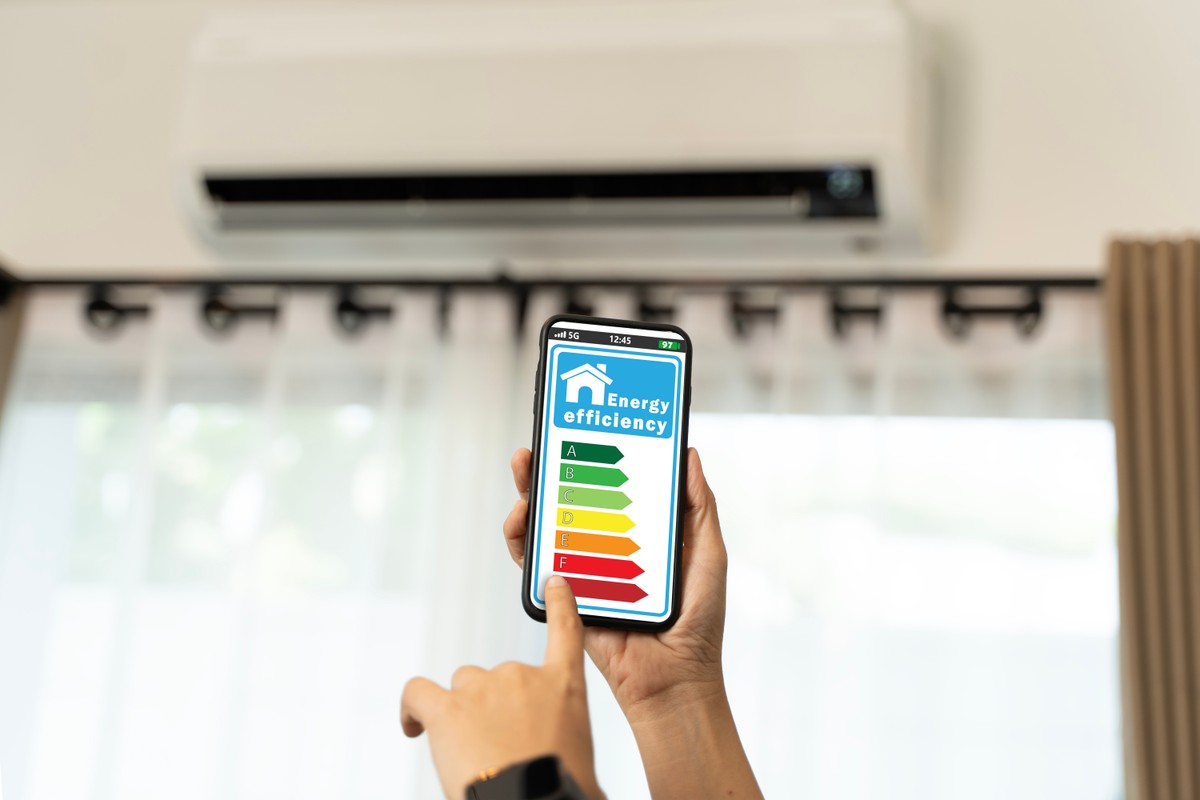 Hand,Holding,Smartphone,Showing,Colorful,Energy,Efficiency,Rating,Chart,With