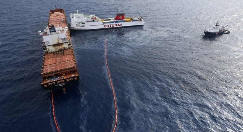 In this file photo taken on October 10, 2018 the French navy ocean tug L'Abeille Flandre (R) approaches two cargo ships - the Tunisian freighter Ulysse (C) and Cyprus-based vessel anchored CLS Virginia (L) - after they collided north of Corsica