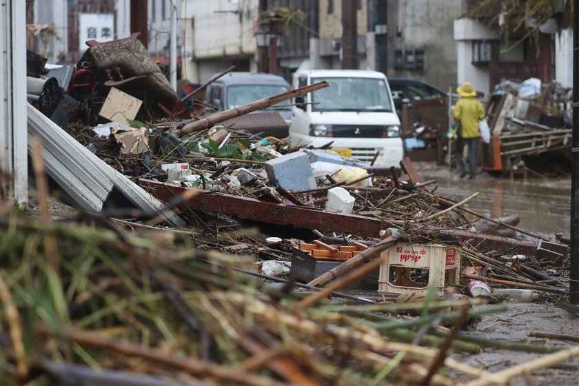 A car is pictured after it was drifted by torrential rain in Hitoyoshi