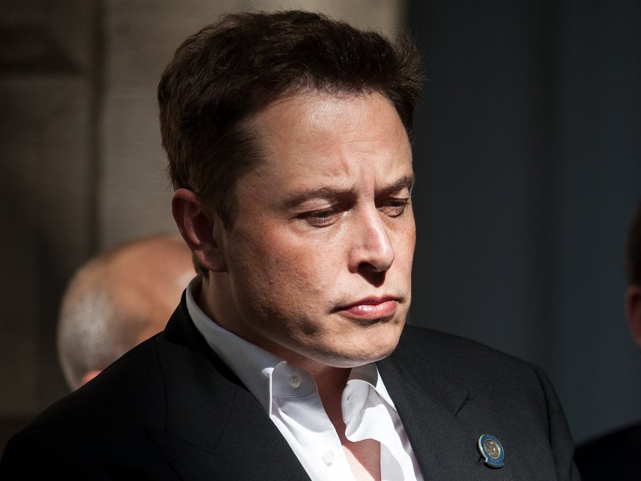 Elon Musk, CEO of Tesla Motors, listens as Governor Brian Sandoval of Nevada speaks during a press conference at the Nevada State Capitol, September 4, 2014 in Carson City, Nevada.