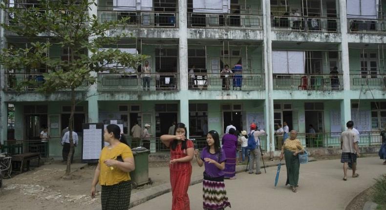 People leave a polling station after casting their votes in Myanmar by-elections, seen as a barometer for growing disillusionment in the country