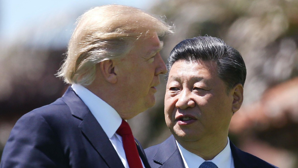 U.S. President Trump and China's President Xi walk together at the Mar-a-Lago estate after a bilater