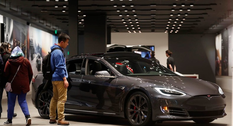 Buyers look over a Model S P100 D in a Tesla store in Cherry Creek Mall in Denver.AP Photo/David Zalubowski