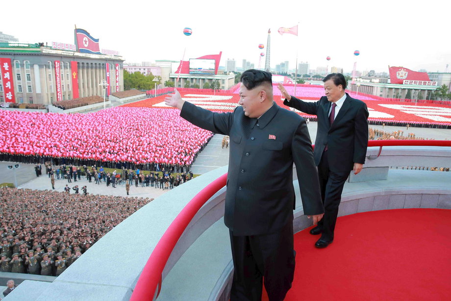 North Korean leader Kim Jong Un (L) and senior Chinese Communist Party official Liu Yunshan (R) wave during celebration of the 70th anniversary of the founding of the ruling Workers' Party of Korea.
